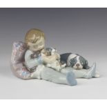 A Lladro group of a young boy with a family of dogs 1535 16cm