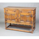 A 17th Century style carved oak sideboard, with arcaded and linenfold decoration, fitted 2 drawers