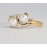 A 14ct yellow gold cultured pearl cross-over ring size M