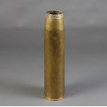 A large brass shell case marked 45 Inmks 3-5 gun, dated 1957