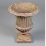 A Victorian style cast iron fluted garden urn with egg and dart border 44cm x 37cm