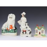 A Victorian money box in the form of a country cottage 11cm, a ditto group of a gentleman and