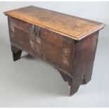 A 17th/18th Century oak coffer of panelled construction the interior fitted a candlebox 55cm h x