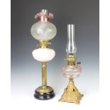 A Victorian faceted peach glass reservoir raised on a pierced iron stand complete with chimney