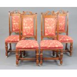 A set of 4 Victorian carved walnut show frame dining chairs, seats and backs upholstered in floral