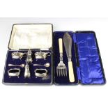 A silver 6 piece condiment set raised on pad feet, cased, Birmingham 1925, 75 grams together with