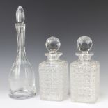 A pair of square cut glass spirit decanters and stoppers 23cm together with a mallet shaped decanter