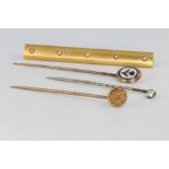 An Edwardian gold tie pin, 2 others and a bar brooch