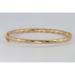 A 9ct yellow gold engine turned bangle 4.7 grams