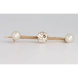 A yellow gold brilliant cut diamond and pearl bar brooch, the centre diamond approx 0.5ct, 32mm