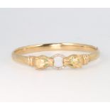 A 9ct yellow gold diamond set double leopard head bangle with emerald eyes, 11.6 grams