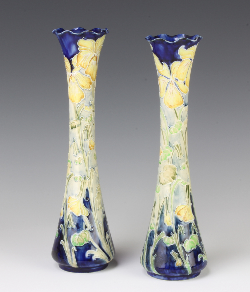 A near pair of William Moorcroft Macintyre Florian Ware waisted vases decorated with yellow irises