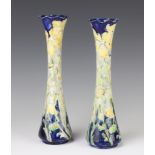 A near pair of William Moorcroft Macintyre Florian Ware waisted vases decorated with yellow irises