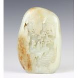 A 19th/20th Century jade boulder carving, the pale grey-green stone with amber inclusions carved