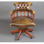 A Georgian style mahogany revolving office chair with bobbin turned decoration, upholstered in green