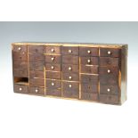 A 19th Century mahogany apothecaries cabinet fitted 36 shallow drawers and with turned ivory handles