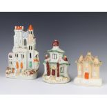 A Staffordshire figure of a castle 23cm, a ditto money bank in the form of a country cottage 16cm