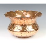 A circular Art Nouveau embossed copper jardiniere with wavy border 16cm x 25cm