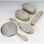 An Art Deco style silver engine turned dressing table set comprising hand mirror, a pair of