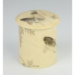 A Japanese Meiji period carved ivory cylindrical box and cover decorated with carp beneath wisteria,