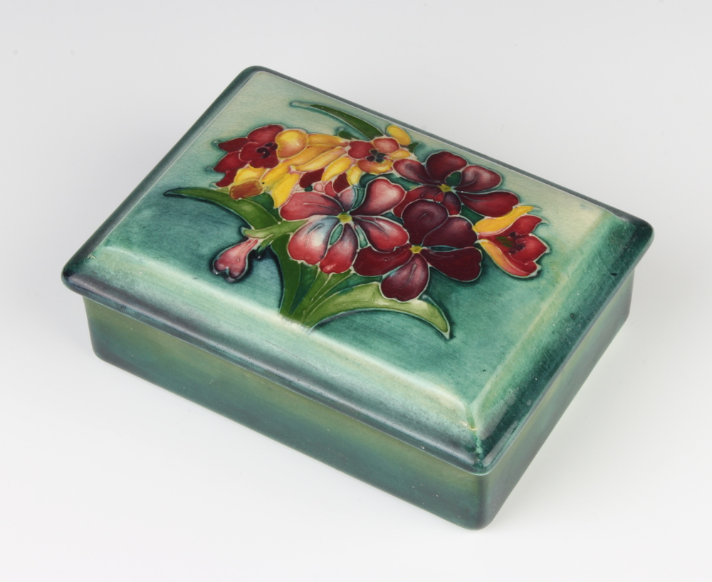 A Moorcroft rectangular box and cover decorated with flowers, with signature, impressed mark and