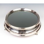 An Edwardian circular silver plated mirrored cake stand 39cm diam. contained in a fitted box