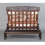 A mid 19th Century painted marble screen, formed of numerous white tablets with brightly coloured