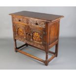 A 17th Century style carved oak side cabinet fitted 2 drawers above a pair of cupboards enclosed