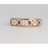 A 9ct yellow gold ruby and diamond half hoop ring 2.4 grams, size Q