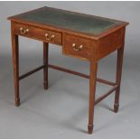 An Edwardian mahogany writing table with inset tooled leather writing surface fitted 2 drawers