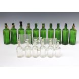 A collection of green and clear glass chemists bottles