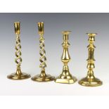 A pair of 19th Century brass spiral turned candlesticks together with 2 other 19th Century brass