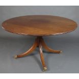 A Regency style circular mahogany snap top breakfast table, raised on a turned column with tripod