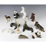 A Russian porcelain figure of a standing bear cub 13cm and 10 other Russian figures