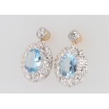 A pair of 9ct yellow gold oval aquamarine and diamond drop earrings, the centre stones approx. 2.5ct