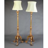 A pair of Italianate style carved and gilt painted standard lamps, raised on tripod supports 43cm