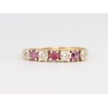 A 9ct yellow gold ruby and diamond half hoop ring 1.8 grams, size R