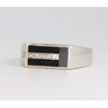A gentleman's 9ct white gold diamond set and onyx ring, size X, 5.5 grams