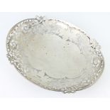An oval pierced silver dish decorated with scrolls, Sheffield 1938, 29 cm, 497 grams