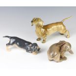 A Continental figure of a standing Dachshund 23cm, a Royal Copenhagen figure of a puppy 17cm and a