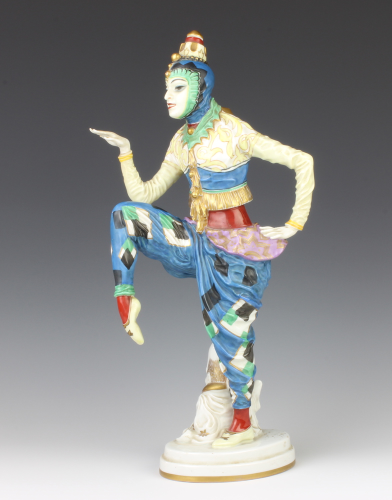 A Rosenthal figure of an exotic dancer, raised on an oval base standing beside a seated figure of