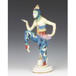 A Rosenthal figure of an exotic dancer, raised on an oval base standing beside a seated figure of