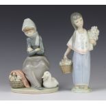 A Lladro figure of a young girl holding a basket of fruit 22cm, a ditto of a seated goose girl