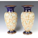 A pair of Doulton Slaters oviform vases decorated with flowers 40cm