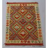 A yellow, green and orange ground Chobi Kilim rug 117cm x 87cm