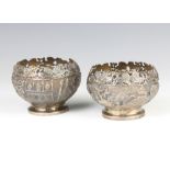 A pair of repousse Indian silver bowls decorated with animals and buildings 163 grams, 8cm
