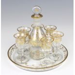 A 19th Century glass and gilt decorated liqueur set comprising decanter 14cm, 6 tots 7cm and a