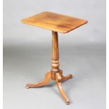 A rectangular Regency mahogany wine table, raised on a turned and fluted column with tripod base