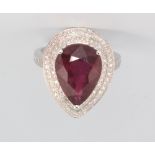 A 14ct white gold pear cut ruby and diamond cluster ring, the centre stone approx. 7.43ct,