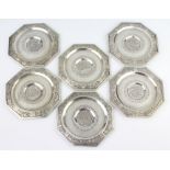 A set of 6 Chinese silver octagonal dishes decorated with farming figures enclosed in pierced bamboo
